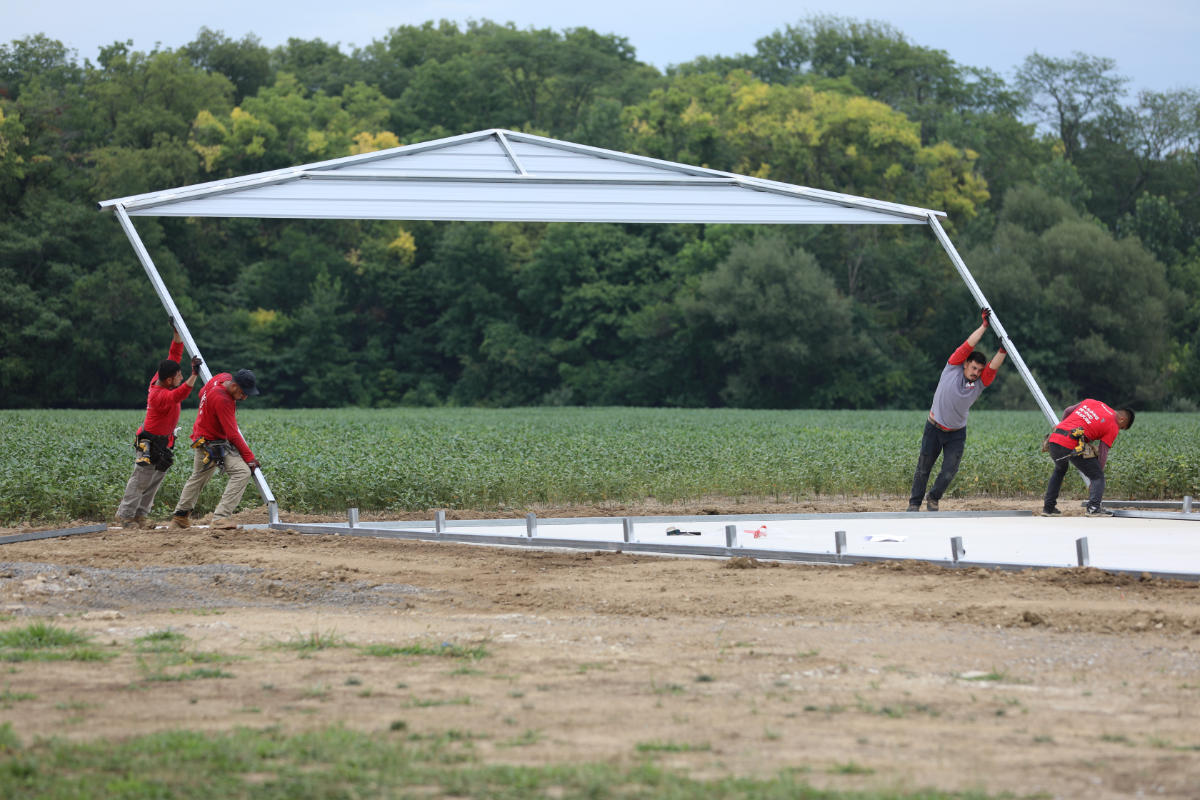 Team of builders raising a steel frame for a metal structure